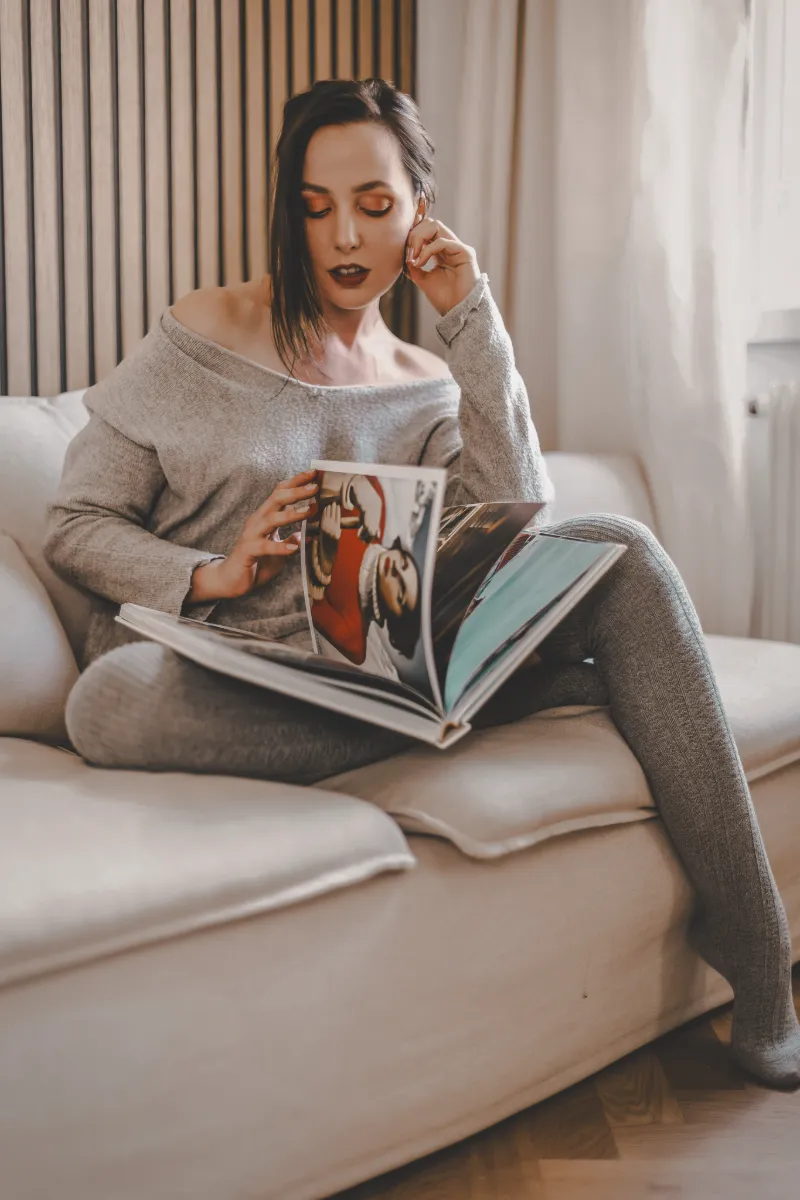 A client - or in this case, the model from a previous session - leafing through a finished photobook on a quiet afternoon.